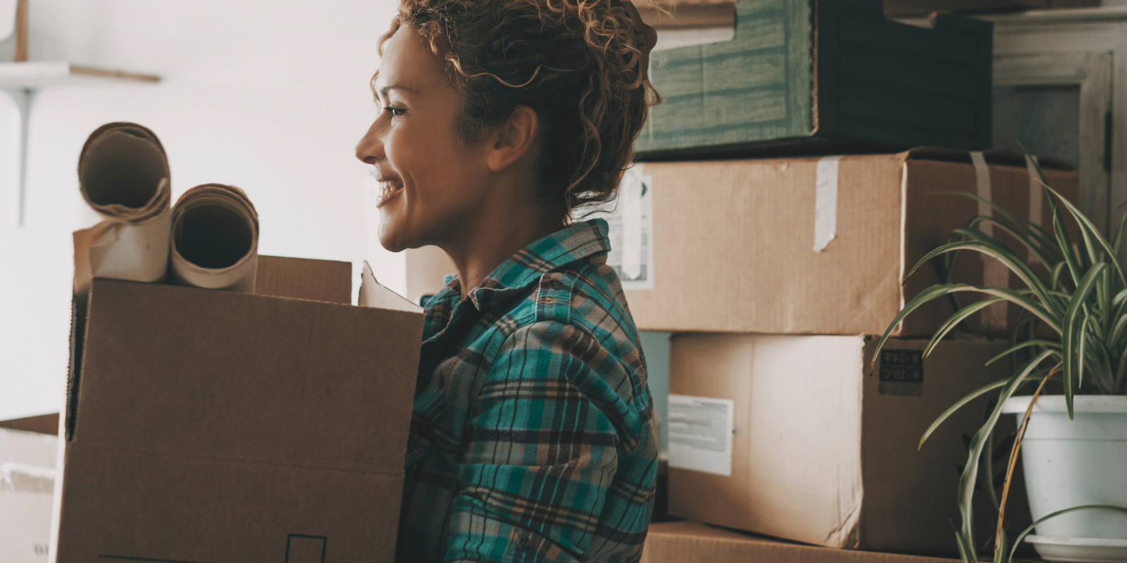 Woman carrying moving boxes