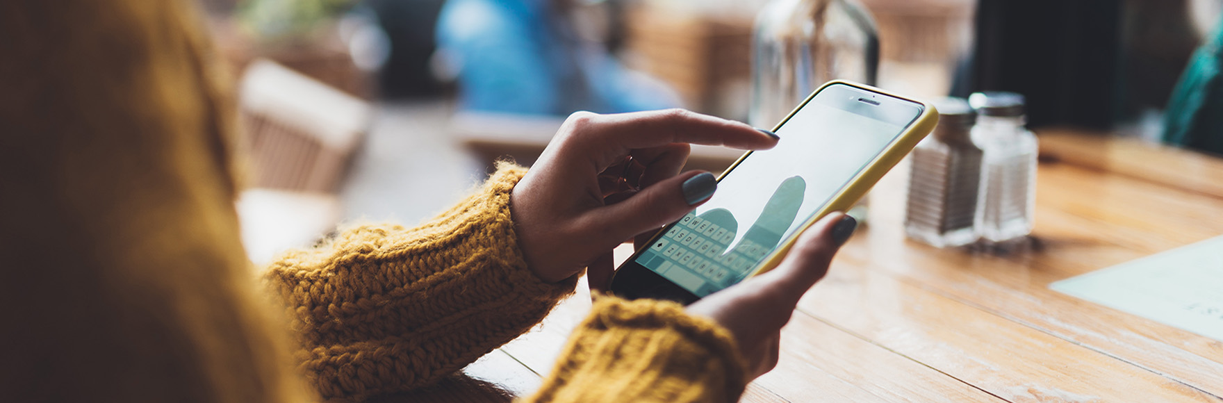 a person using their mobile device to text