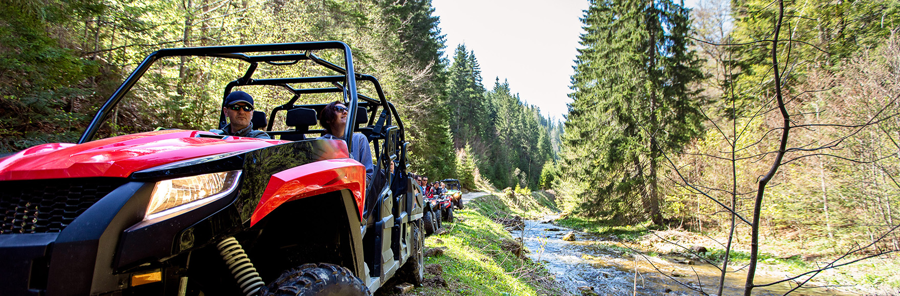 two people riding in an ATV 