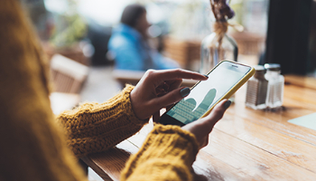 a woman swiping on her mobile phone