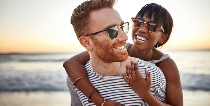 a couple wearing sunglasses and smiling