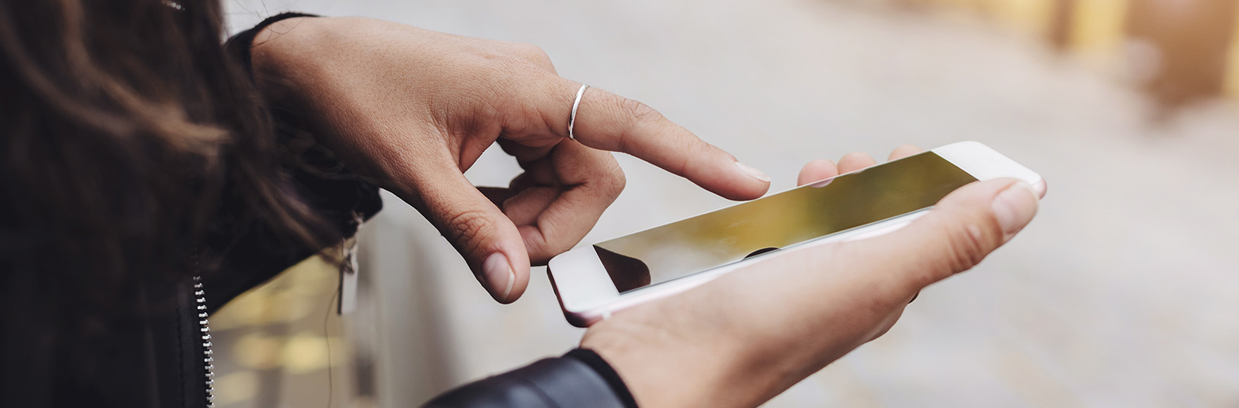 a hand touch a mobile phone screen