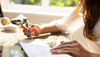 a woman writing on a paper checking